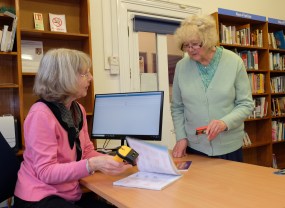 A visitor borrowing a book from Love Weston Library