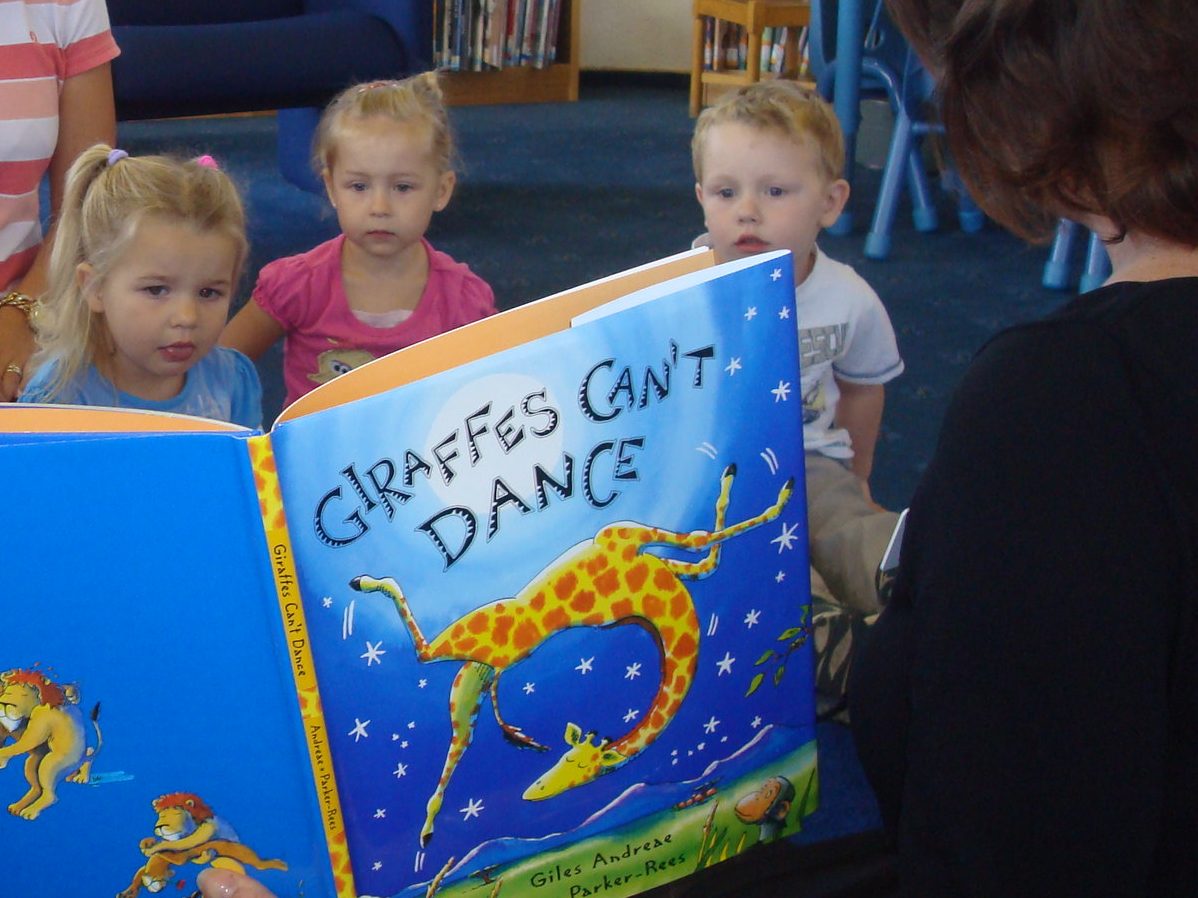 Toddlers listen to a story in their local library